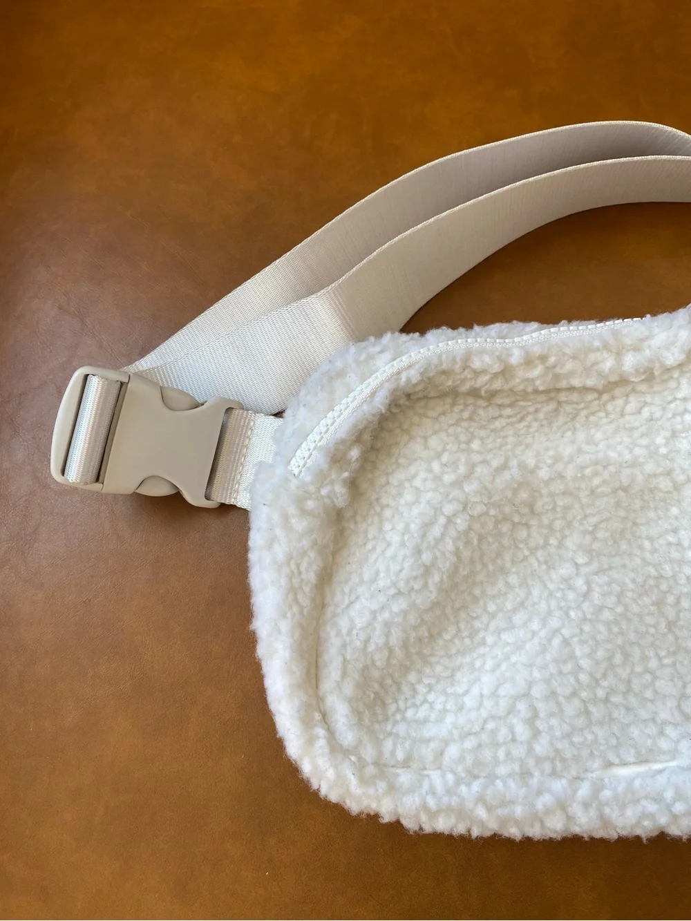 Fabletics The Belt Bag Teddy in color Bone Sherpa Crossbody Bag with Wide Strap